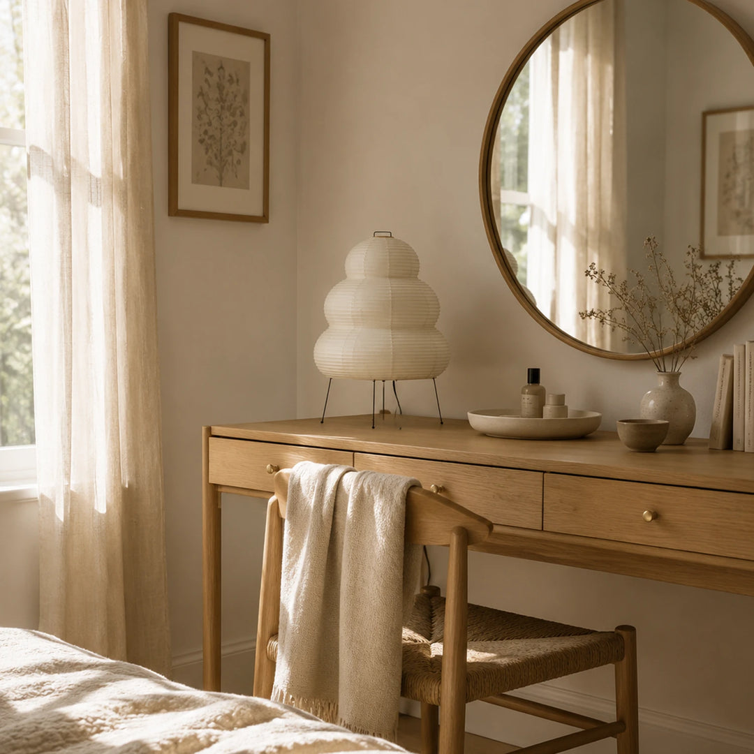 Tiered paper table lamp on a sideboard with styled vases and greenery