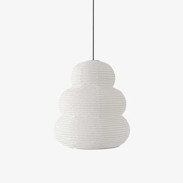 Tiered stacked mulberry paper pendant light with a black cord on a soft grey background