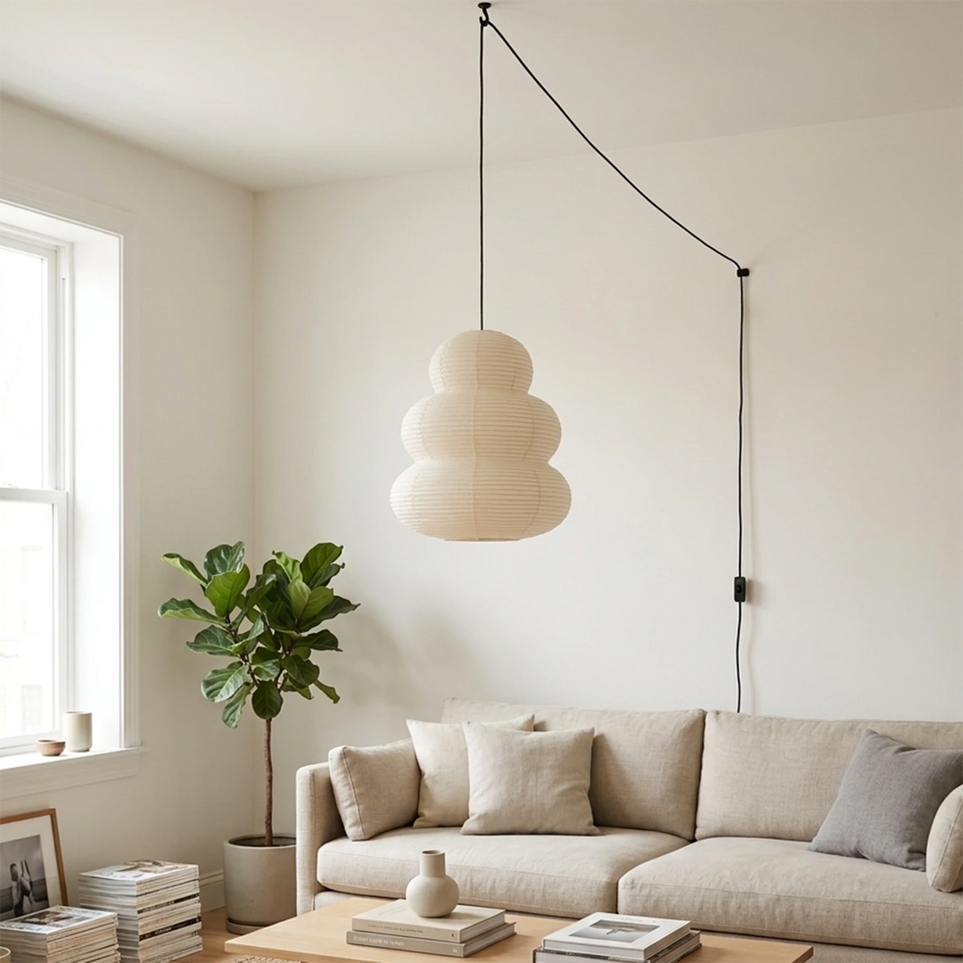 Tiered paper pendant in a daylit living room above a sectional sofa