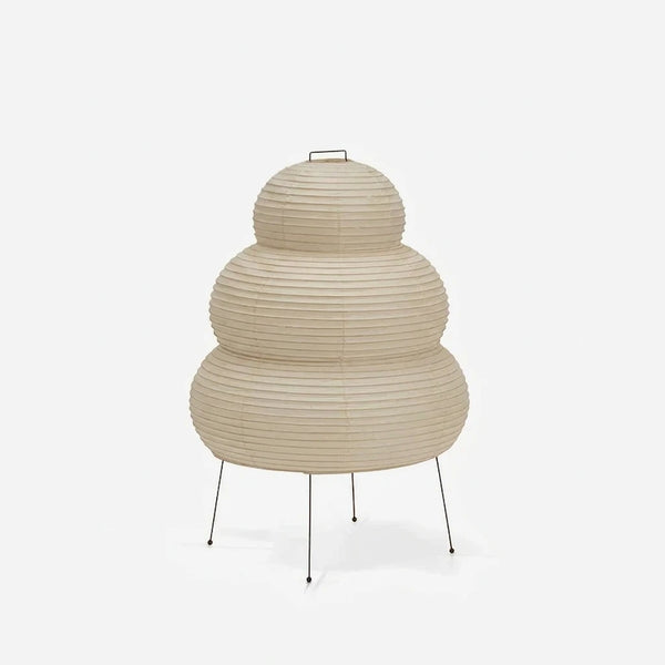 Tiered stacked mulberry paper table lamp with a tripod base on a soft grey background