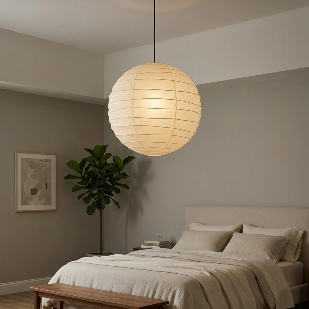 Paper pendant hanging in a high-ceilinged bedroom with soft daylight