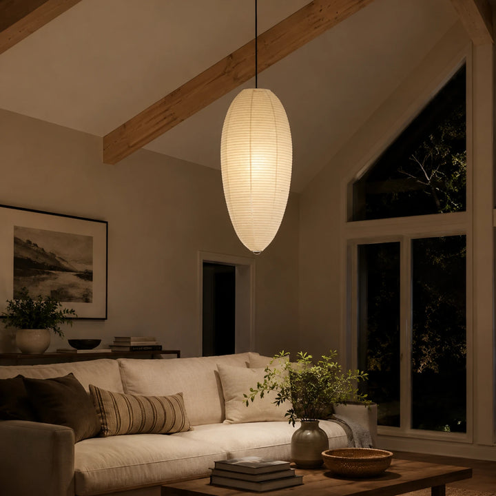 Oval paper pendant under a vaulted ceiling beside a dark night window
