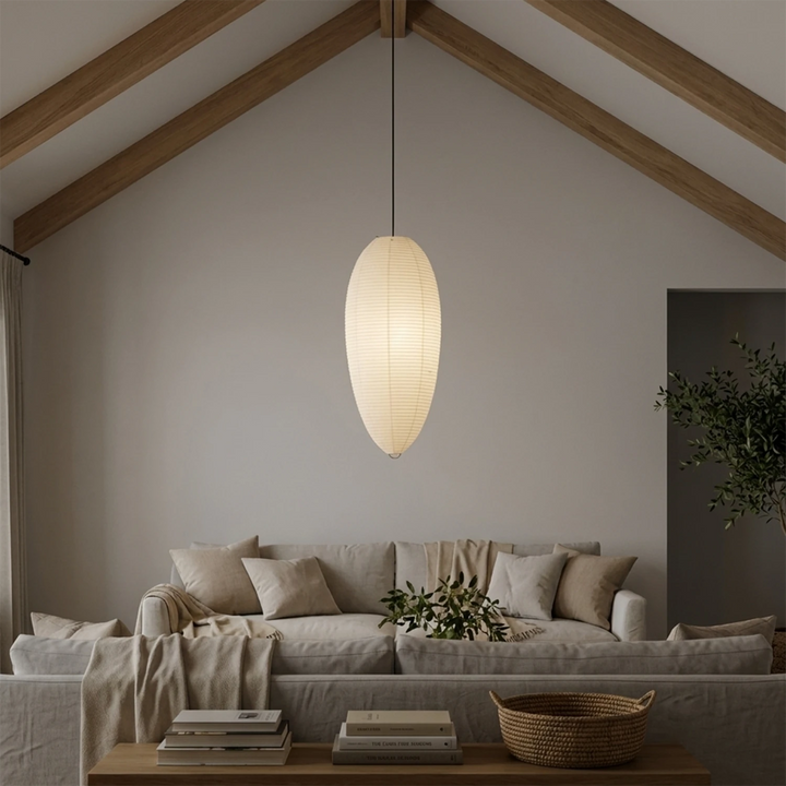 Oval paper pendant in a vaulted lounge with garden-facing glass doors