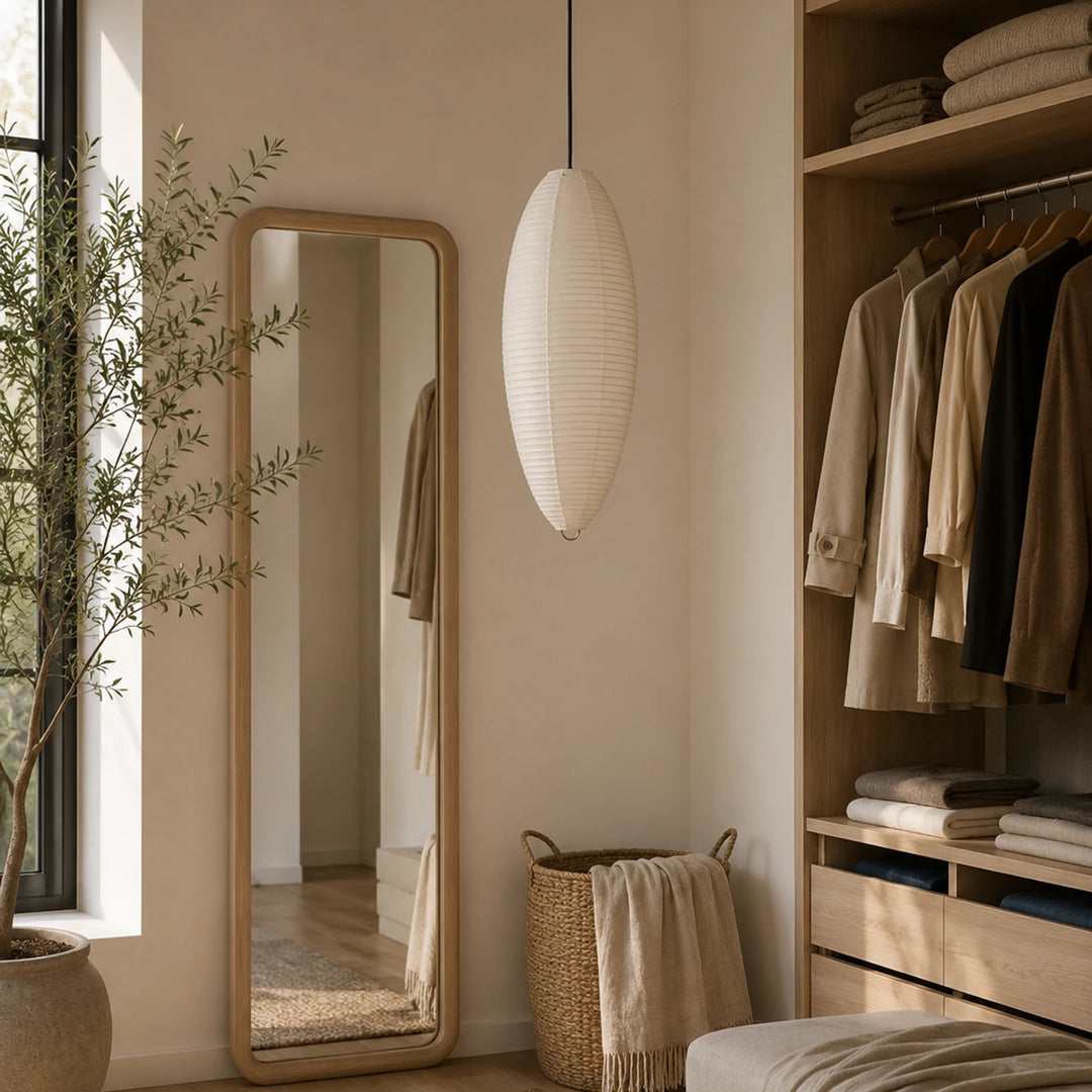 Oval paper pendant lighting a walk-in wardrobe corner beside a tall mirror