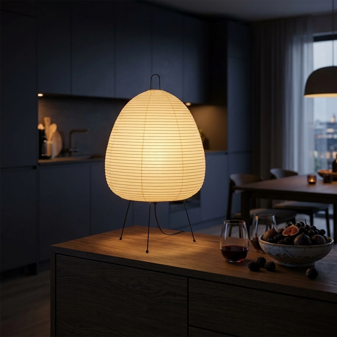 Warm-glowing paper lamp on a wooden credenza in a deep navy living room