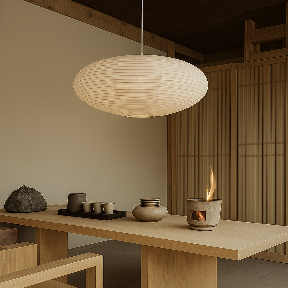Warm oval washi paper pendant hanging in neutral japanese style tea room with wooden cabinetry