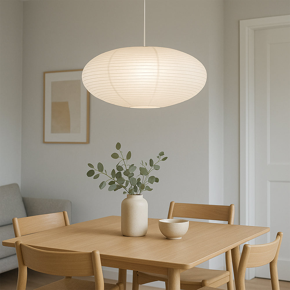 Medium size oval washi paper pendant above round wooden dining table in wabi-sabi dining room