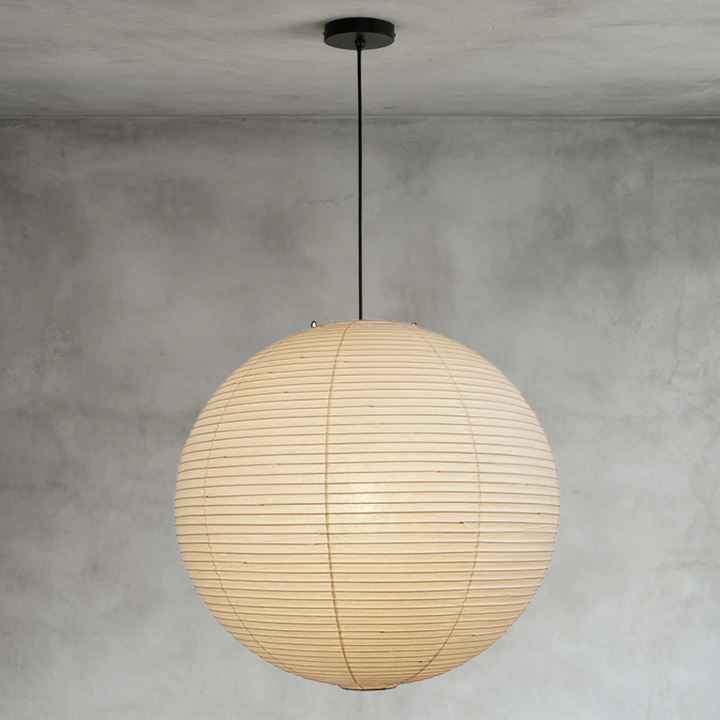 Washi paper spherical pendant in bright lounge with full floor-to-ceiling glass windows