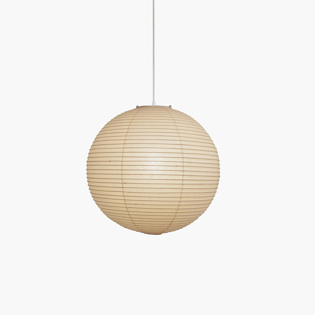 Mini washi paper sphere lamp with slim white suspension cord against clean plain light wall